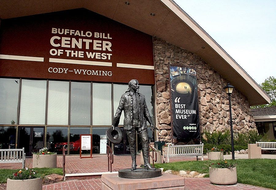 While Bob Scriver's sculpture Buffalo Bill - Plainsman greets visitor to the Buffalo Bill Center of the West, a banner quotes a TripAdvisor review declaring the Center the