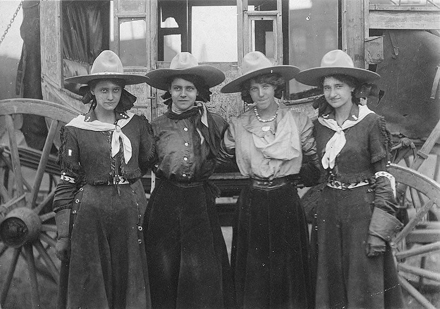 Four Cowgirls in Front of Stagecoach, 101 Ranch Show, ca. 1916. Sepia toned photograph. MS 6 William F. Cody Collection. P.69.1289
