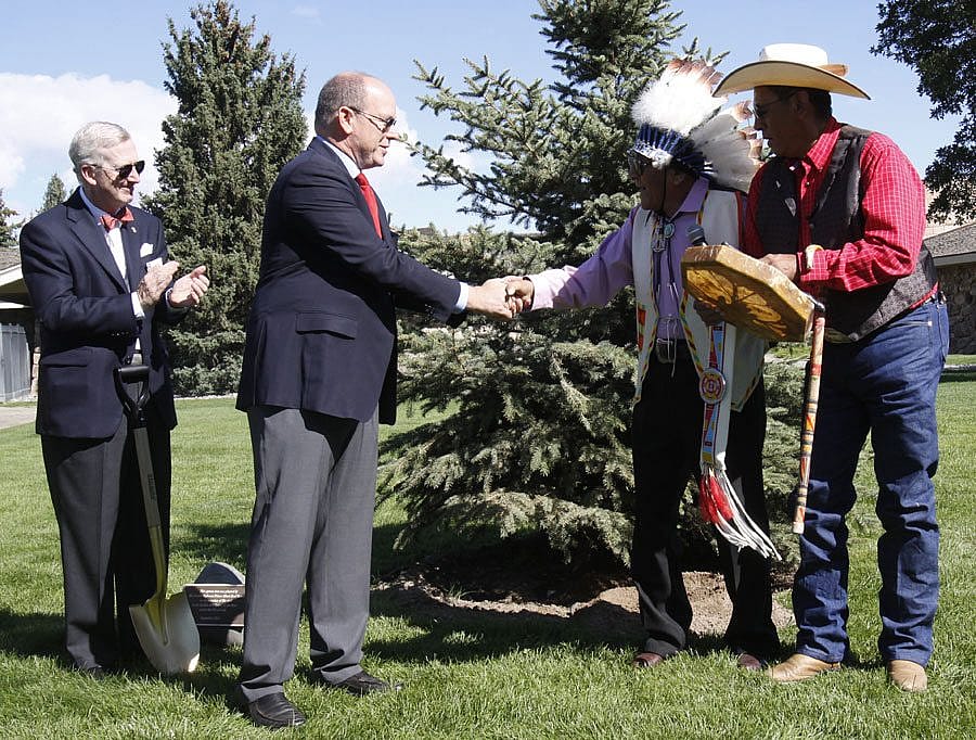 Prince Albert II of Monaco shaking hands with Crow elder Joe Medicine Crow