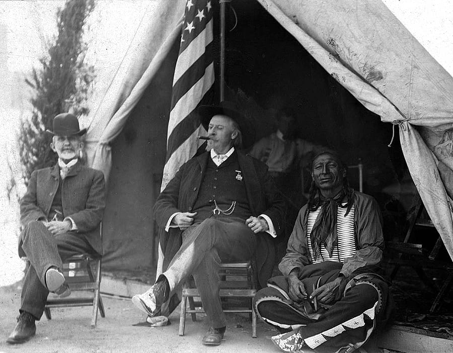 Nate Salsbury's work with Buffalo Bill's Wild West afforded him the experience to strategize a new exhibition, Black America. Here he's pictured with William F. Cody and Chief Iron Tail, ca. 1900, in front of Wild West show tent. MS 6 William F. Cody Collection, McCracken Research Library. P.69.1020