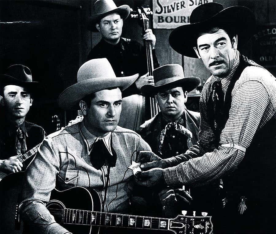 "Bar Buckaroos" (1940) was one of Ray Whitley's few star roles in the movies. Seen here with his trusty Gibson guitar, Whitley is better remembered as the writer of "Back in the Saddle Again" and other western classics. Photo courtesy Country Music Hall of Fame.
