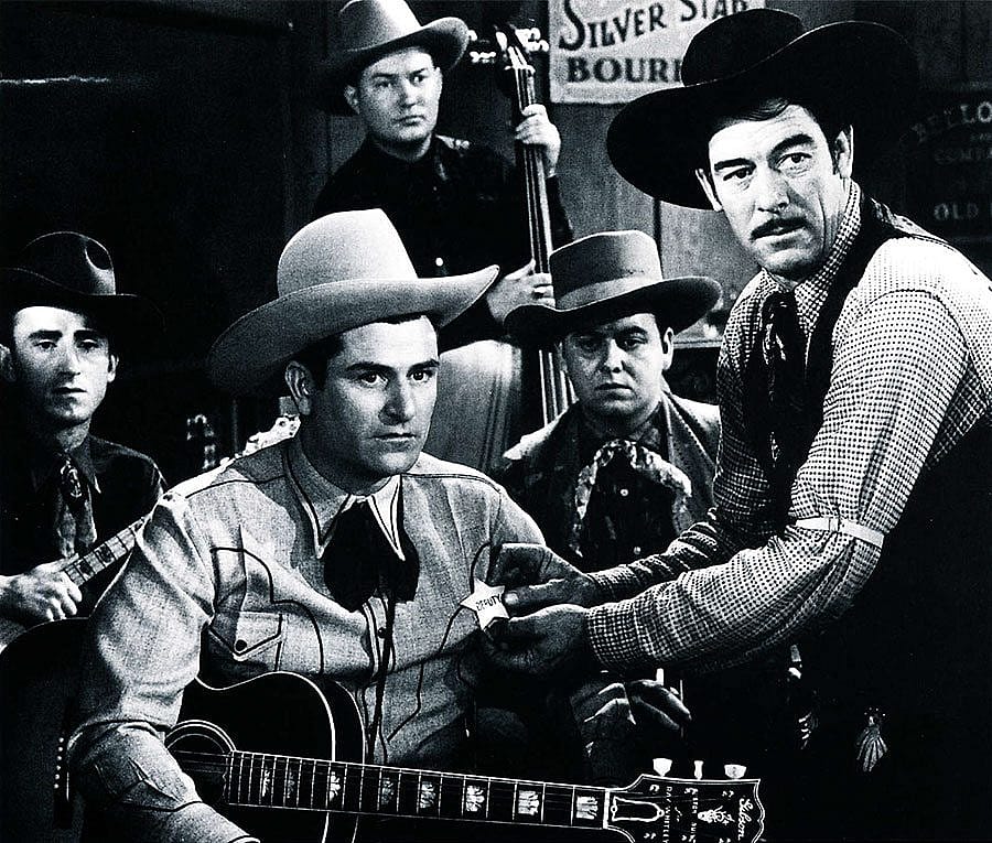 "Bar Buckaroos" (1940) was one of Ray Whitley's few star roles in the movies. Seen here with his trusty Gibson guitar, Whitley is better remembered as the writer of "Back in the Saddle Again" and other western classics. Photo courtesy Country Music Hall of Fame.