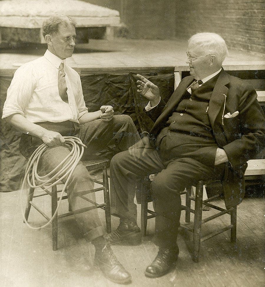 Alexander Phimister Proctor and Dr. H.W. Coe discuss the Teddy Roosevelt sculpture project in Proctor's studio with the forelegs of the "Rough Rider" in the background. P.242.1044