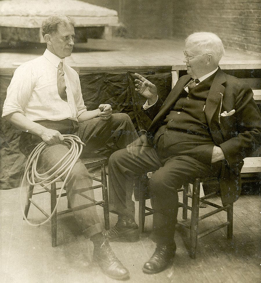 Alexander Phimister Proctor and Dr. H.W. Coe discuss the Teddy Roosevelt sculpture project in Proctor's studio with the forelegs of the "Rough Rider" in the background. P.242.1044