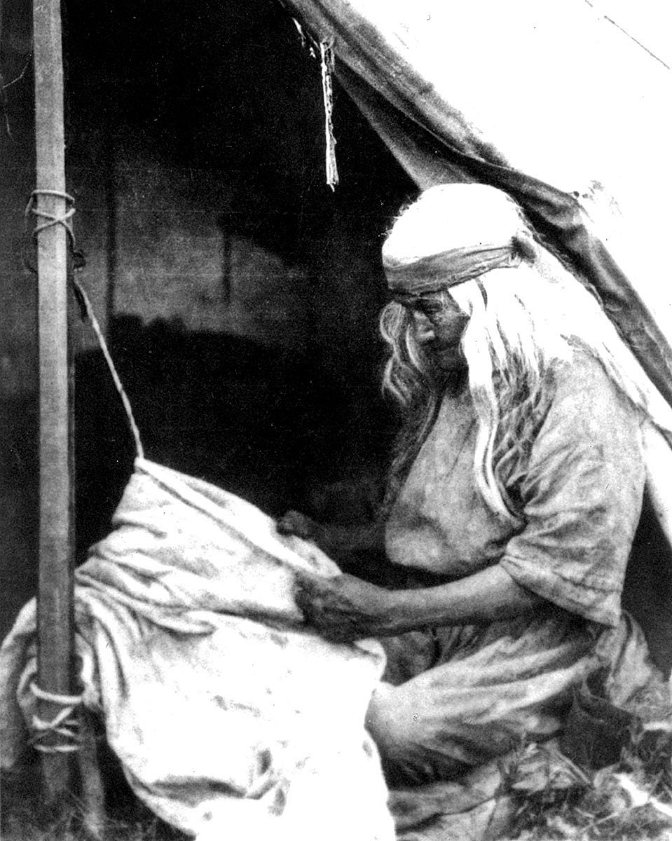 American Indian woman softening hide on rope, ca. 1880-1900. MS 35 North American Indian Photograph Collection. P.35.48