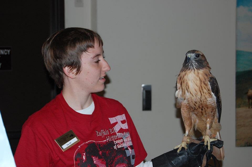 One of our interns, Sarah, and Isham the red-tailed hawk.