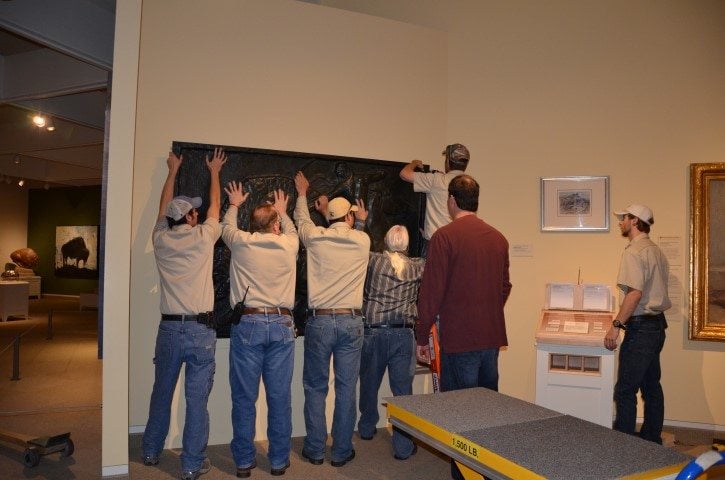 How many people does it take to hang a 600 pound bronze?