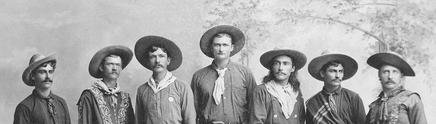 In this ca. 1886-1887 photograph, nine cowboys from Buffalo Bill's Wild West show are pictured in their western finery. MS 6 William F. Cody Collection, McCracken Research Library. P.6.86 (detail)