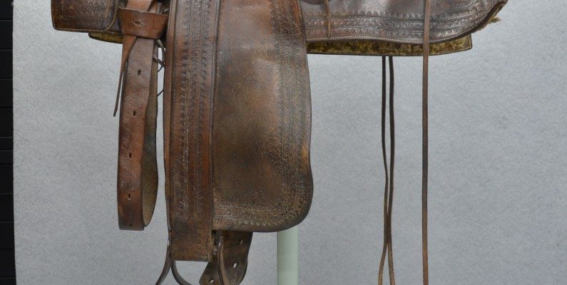 A saddle owned and used by Buffalo Bill in the conservation lab before treatment. Acc# 1.69.875