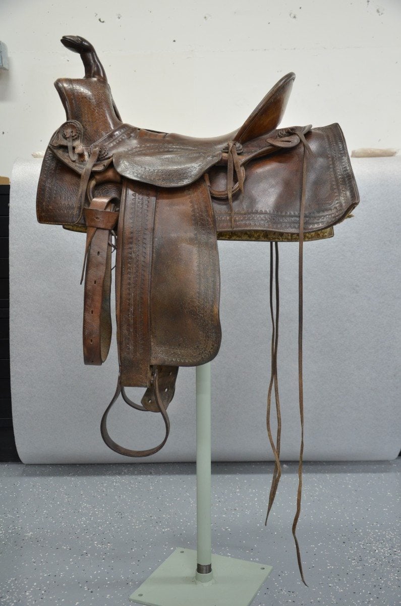 A saddle owned and used by Buffalo Bill in the conservation lab before treatment. Acc# 1.69.875
