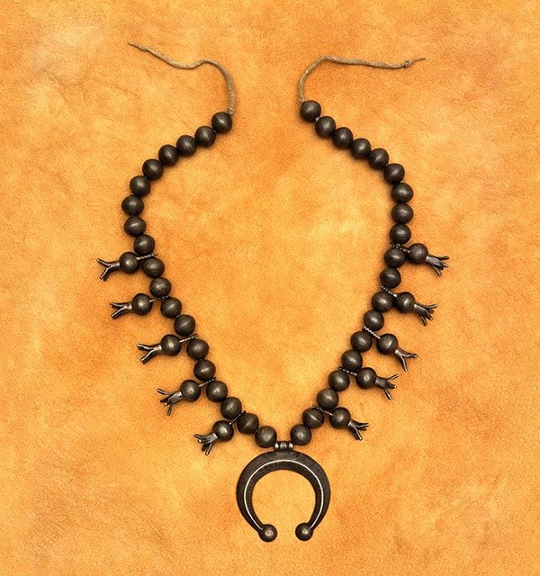 Adornment in the West: Squash blossom necklace, Navajo. Gift of Betty Lou Sheerin. NA.203.1355.