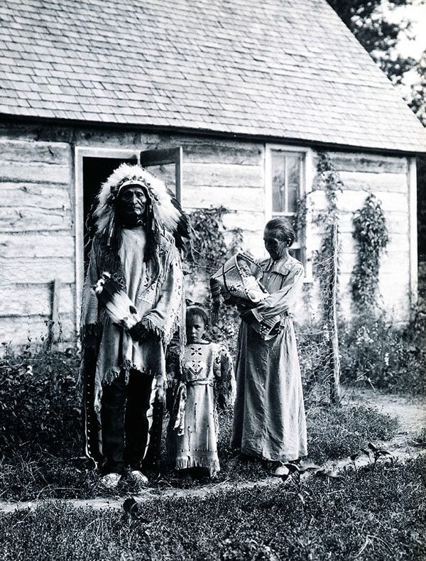 Standing Bear, Rose Two Bonnets, Lula Two Bonnets, and Louisa Standing Bear in front of their home, 1919. Photograph courtesy of Arthur Amiotte.