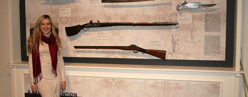 Cody Firearms Museum Curator Ashley Hlebinsky reviews labels in the Combination Arms section of "Journeying West: Distinctive Firearms from the Smithsonian" at the Buffalo Bill Center of the West.