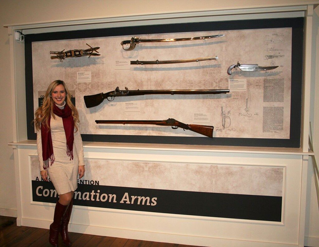 Cody Firearms Museum Curator Ashley Hlebinsky reviews labels in the Combination Arms section of "Journeying West: Distinctive Firearms from the Smithsonian" at the Buffalo Bill Center of the West.