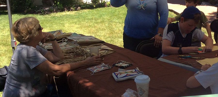 Oglala Lakota artist Jen Runs Close to Lodge (standing), along with Museum Educator Brian Gedron, leads a parfleche-making workshop at the Center of the West June 5 and 6.