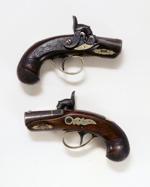"W.F. Cody 1865" is engraved on this Deringer pocket pistol. This is one example of a percussion cap system. Gift of the Klaz Family. 1.69.1800