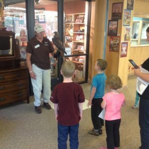 Sally and Isham teaching visitors about red-tailed hawks.
