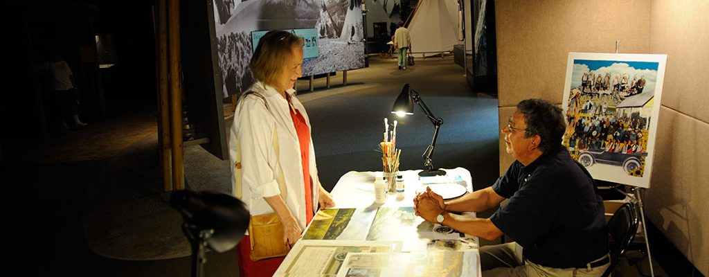 Arthur Amiotte demonstrating his work in the Plains Indian Museum gallery.