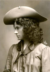 Portrait of Annie Oakley wearing a light hat with a star on brim, kerchief, and blouse, ca. 1902, P.69.1161