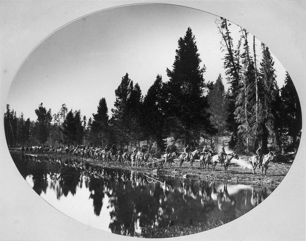 The Hayden party, roughly thirty in number, at Mirror Lake, the divide between the Yellowstone and the Lamar Rivers. Hayden is the second from the right behind his field manager James Stevenson. The Hayden Survey was a major effort to bring home the reality of the Yellowstone basin. WHJ-A.055