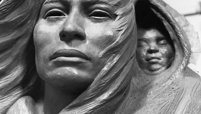 Detail of clay model of Sacajawea and baby.