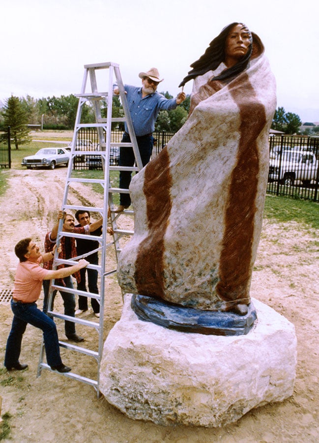 Harry stretches with a brush to put finishing touches on "Sacajawea" once she'd been placed in the Cashman Greever Garden of the Buffalo Bill Historical Center (now the Buffalo Bill Center of the West) prior to her dedication on July 4, 1980.