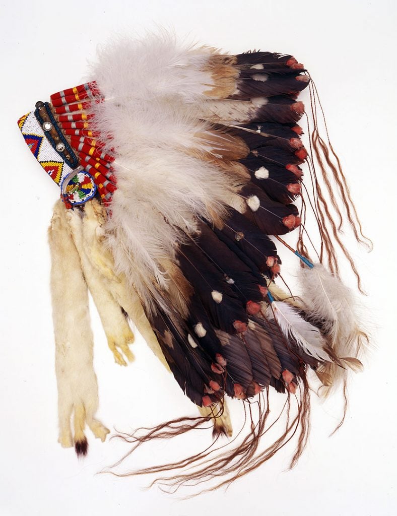 Bonnet, Northern Plains, ca. 1920. Golden eagle feathers, ermine skin, cloth, quills, horsehair. NA.206.65