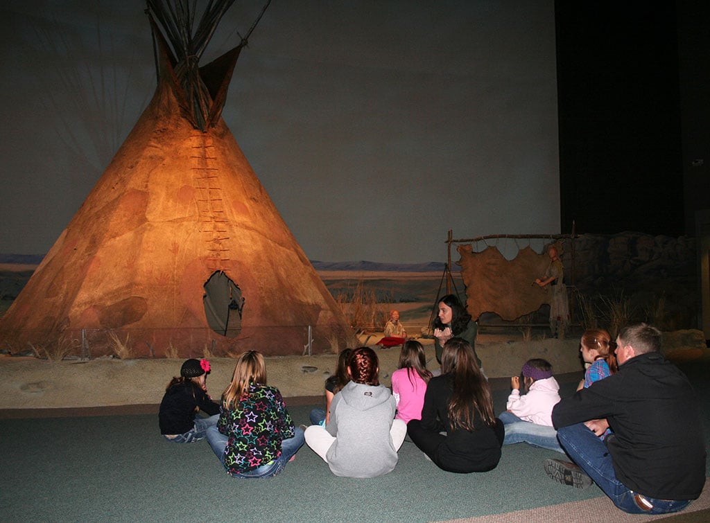 Educator Megan Smith with a MILES group in the Plains Indian Museum.