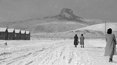 Japanese-American women walk to their barracks at Heart Mountain Relocation Center. MS 89 Jack Richard Photograph Collection, McCracken Research Library. PN.89.111.21238.3 (detail)