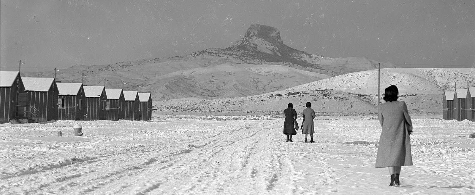 Japanese-American women walk to their barracks at Heart Mountain Relocation Center. MS 89 Jack Richard Photograph Collection, McCracken Research Library. PN.89.111.21238.3 (detail)