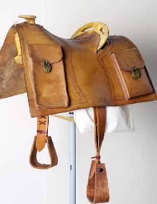Pony Express style saddle with mochilla. Stamped left side front: PONY EXPRESS/MARCH 3RD 1860, Stamped left side back: LOUIS HOOK/S.L. CITY, Stamped right side front: JULY/24TH 1897, Stamped right side back: LOUIS HOOK/S.L. CITY. This is a reproduction possibly used in Wild West Show performances. Date: March 3, 1860; July 24, 1897 Credit: Museum purchase, Garlow Collection. 1.69.16