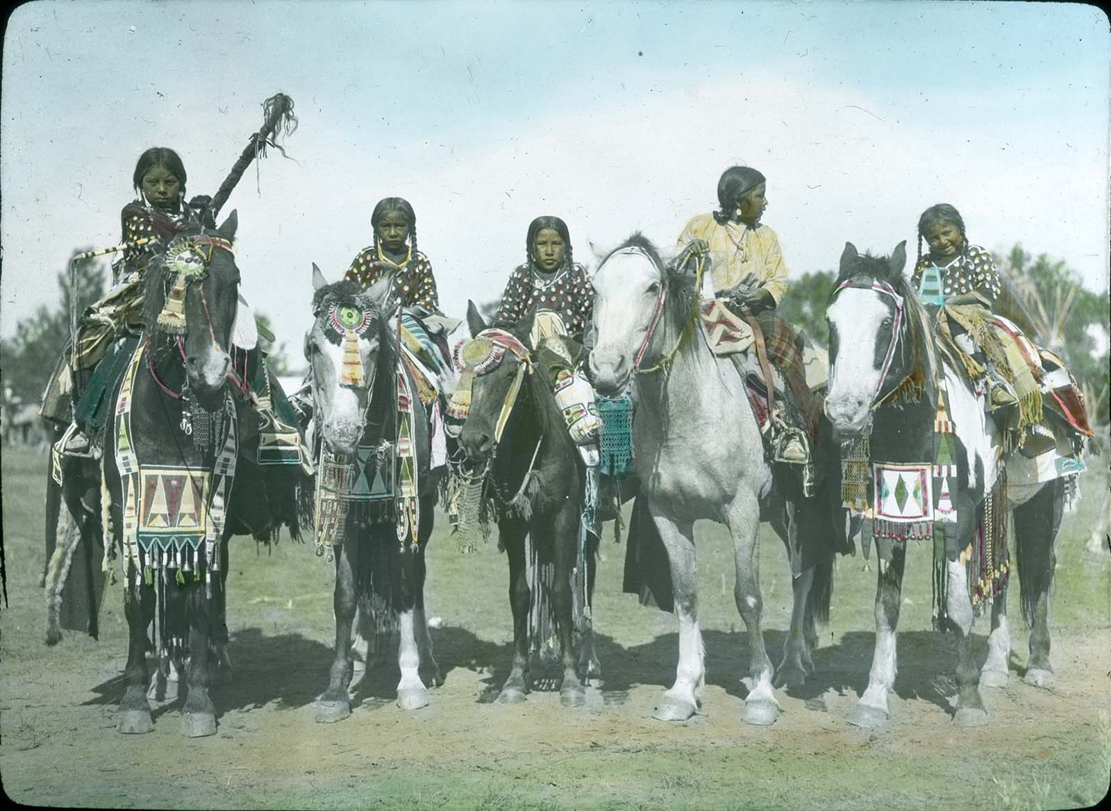 Young Crow girls on their parade horses. Lantern slide. William A. Petzoldt Collection, McCracken Research Library. LS.95.305