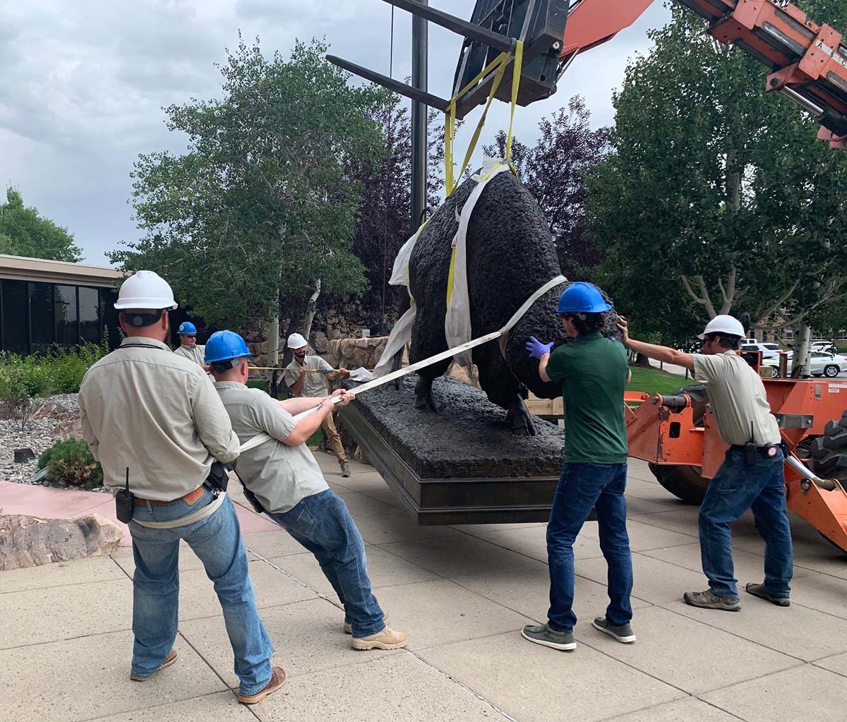 The Center's Facility crew guides the sculpture toward its new home.