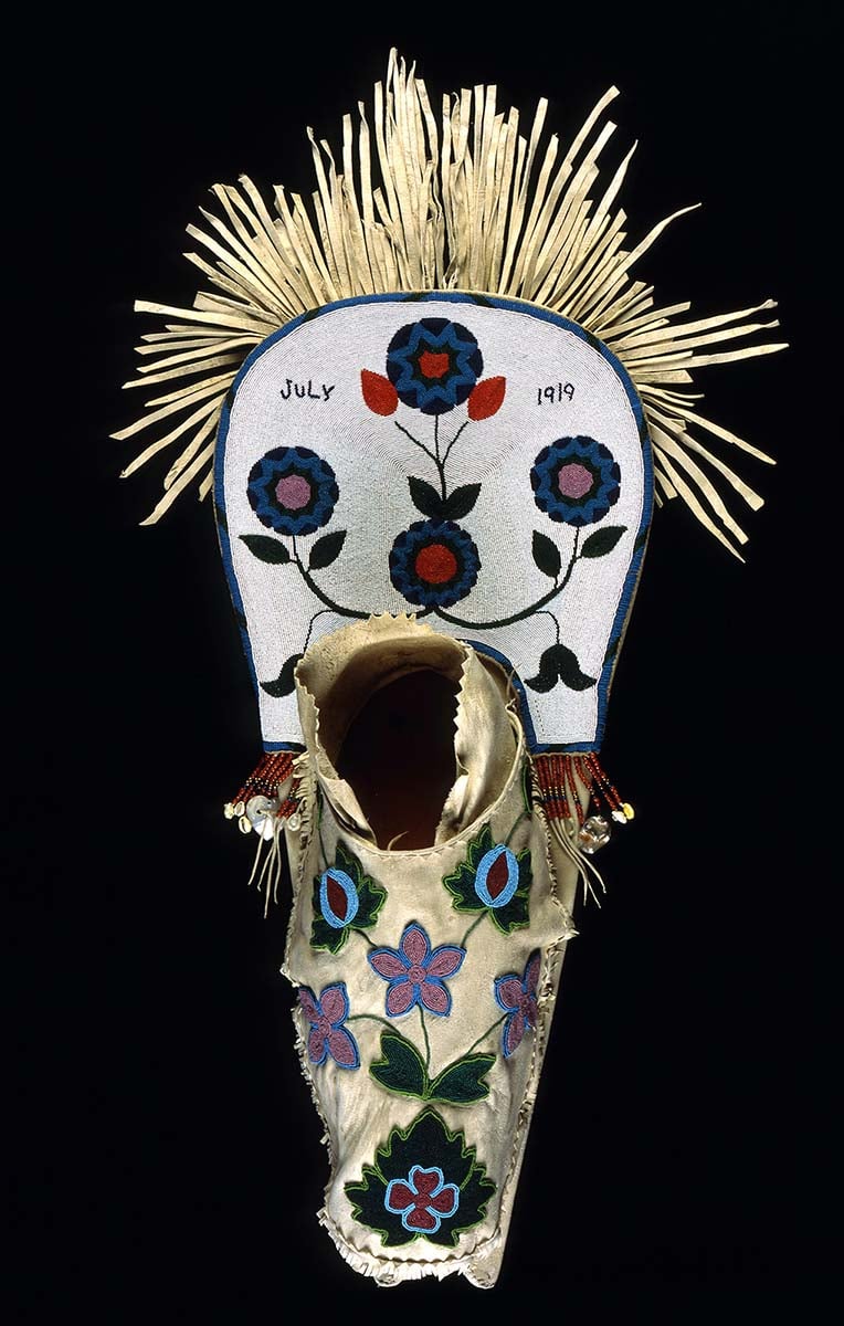 Cradleboard, Salish, Plateau 1919. Wood, tanned hide, muslin, glass beads, cowrie shells, abalone shells, mother of pearl, brass Simplot Collection, Gift of J.R. Simplot; NA.111.57