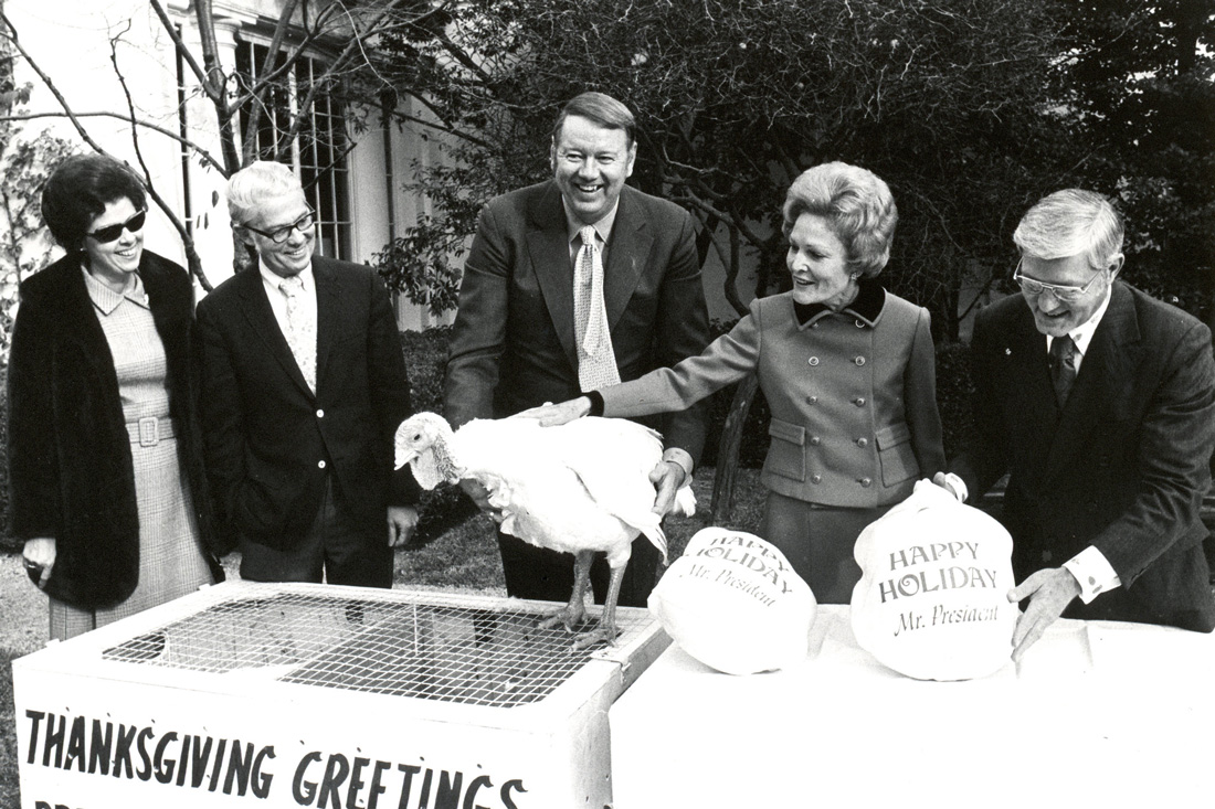 Nixon's Wife, Patricia accepting a live turkey and two ready to roast turkeys in packages.  