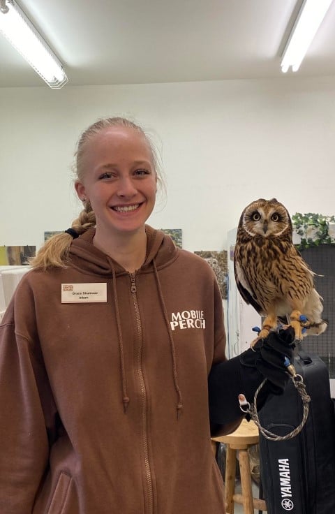 Young woman holding owl