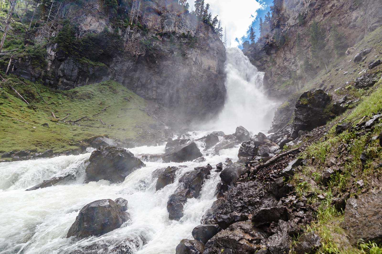 A cloud of mist hangs in the air where Osprey Falls pours into the Gardner River in Yellowstone National Park. Photo by Jacob W. Frank.