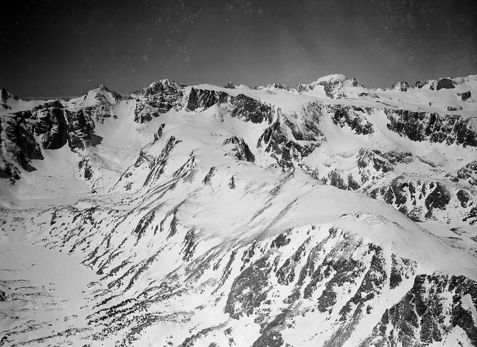 Aerial view of snowy Wind River Mountains with Dinwoody Lake on left, Dinwoody Glacier above lake, and Gannett Peak on right.. MS 3 Charles Belden Collection. PN.67.470b
