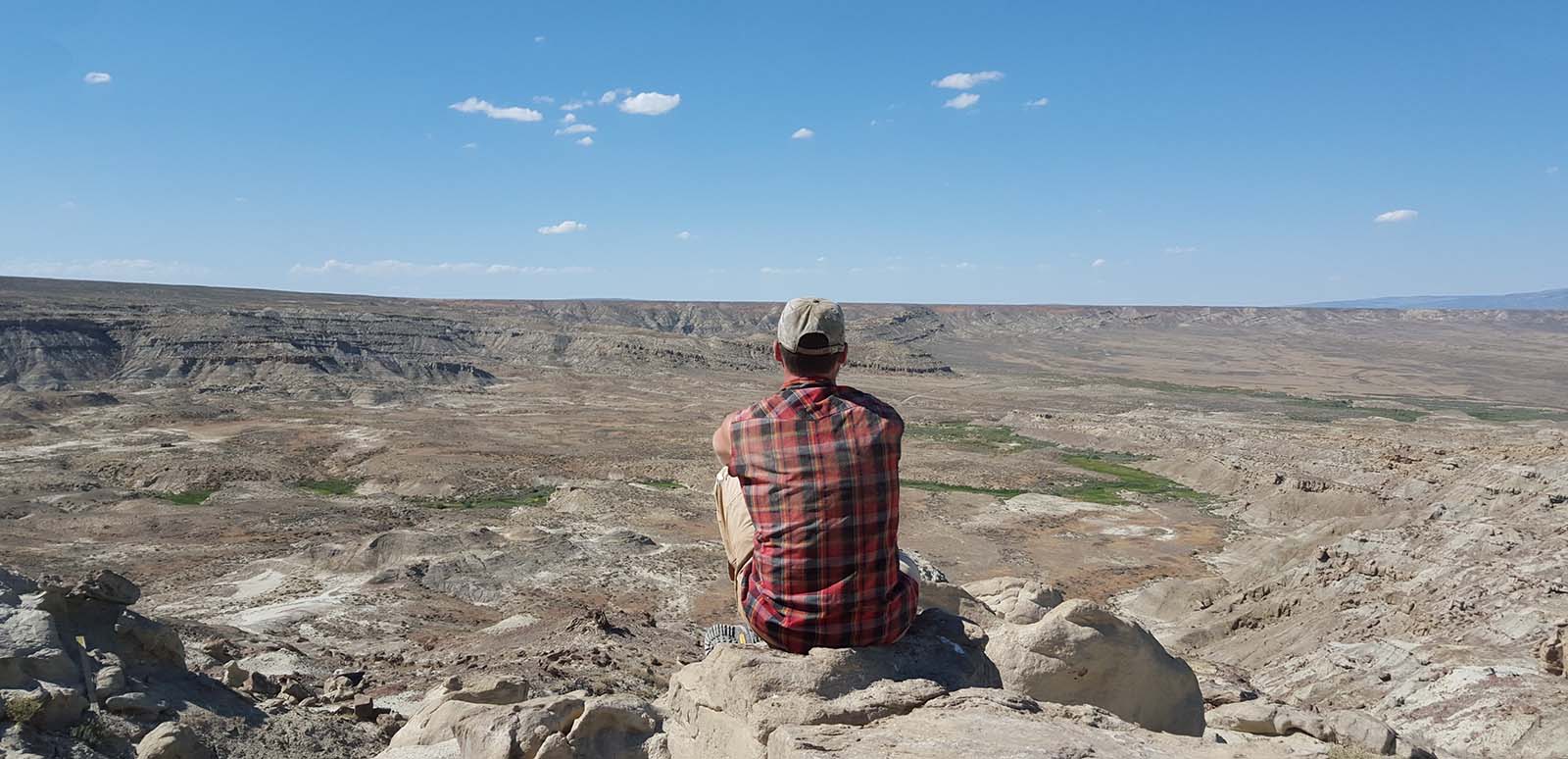 Jason Schein in the field, overlooking the landscape of the Bighorn Basin. Courtesy photograph.