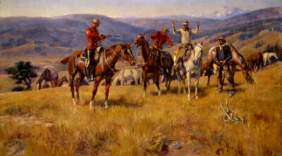 A Royal Canadian Mounted Police officer points a rifle at a mounted man, whose hands are up. Charles M. Russell (1864-1926). "When Law Dulls the Edge of Chance," 1915. Oil on canvas, 30 x 48 inches. Gift of William E. Weiss. 28.78