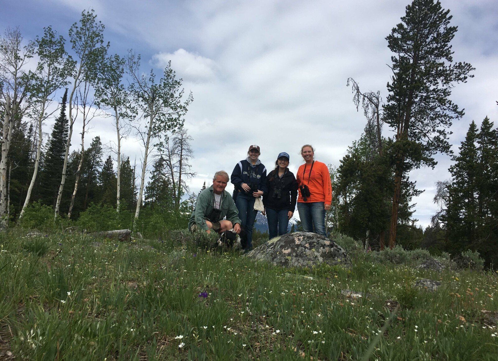From left, Eric C. Atkinson, Chloe Winkler, Kayla Harakal (Berg), and Becky Watkins (plus Shep the American Farm Collie) at the Lily Lake avian disease study site in the Beartooth Mountains.
